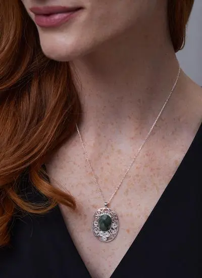 Close up of red haired model wearing Sterling Silver Connemara Marble Newgrange Pendant